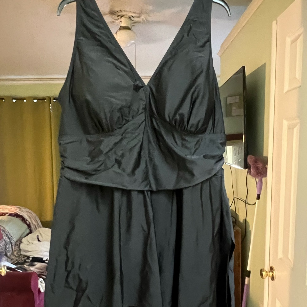 Black swimsuit by torrid with ruching and feminine hemline.  Worn once